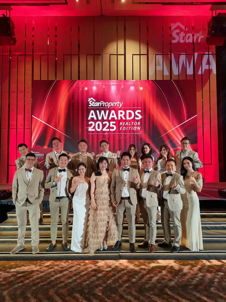 A group posing on the StarProperty Awards 2025 Realtor Edition stage.