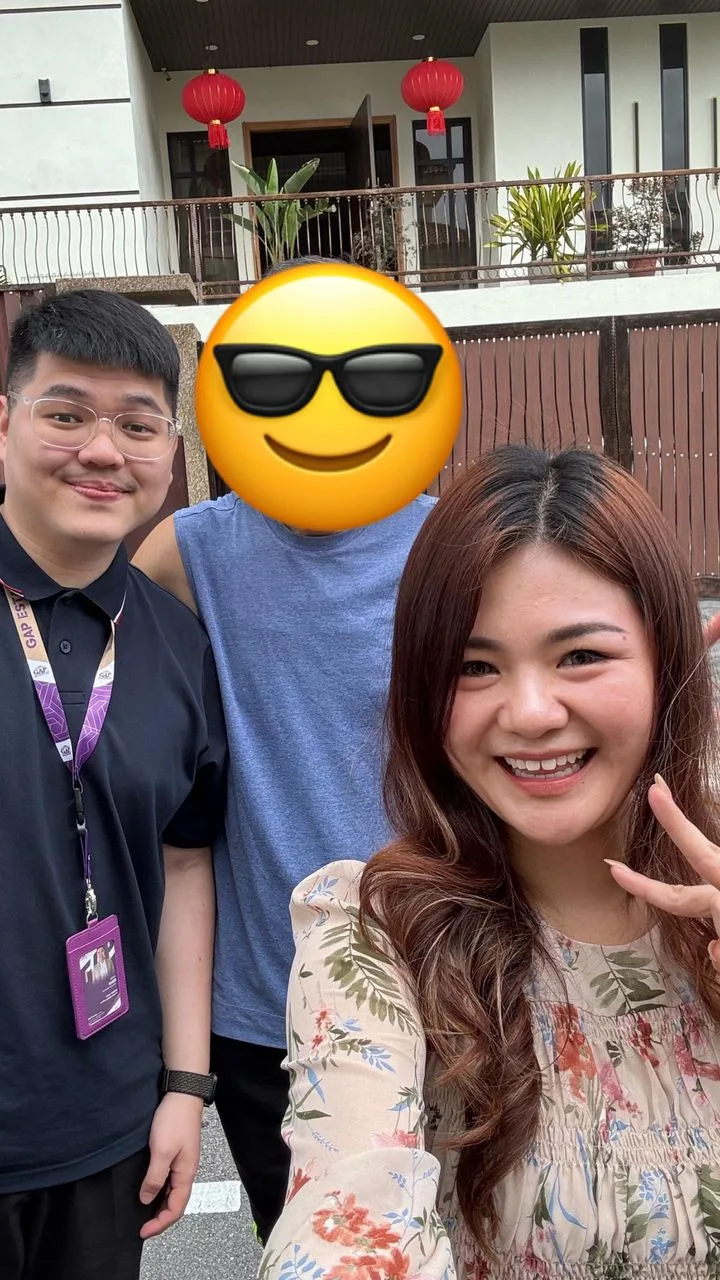 Three people taking a selfie outside a building, with the centre face covered by emoji.